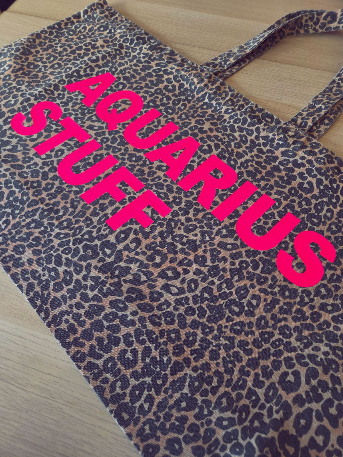 Personalised leopard print tote bag shown carried on shoulder strap